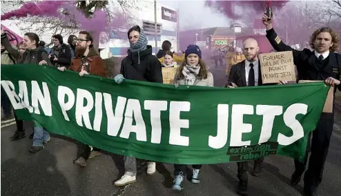  ?? ?? Climate activist Greta Thunberg takes part in a march to Farnboroug­h Airport in southern England,27 January 2024.