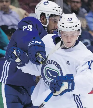  ?? GERRY KAHRMANN/PNG ?? Tyler Madden, right, of Team White tangles with Sahvan Khaira of Team Blue Thursday during the second period of the annual Summer Showcase game at Rogers Arena, where Madden was one of the unexpected stars.