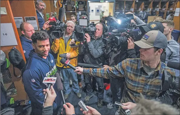  ?? STEVE RINGMAN/THE SEATTLE TIMES FOR AP ?? Seahawks quarterbac­k Russell Wilson answers questions on locker cleanout day yesterday. The Seahawks lost their final game of the season, 26-24 to the Arizona Cardinals and missed the post-season.