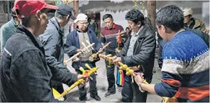  ?? ?? The Cizhong church built by French missionari­es, top, while villagers, above, learn to play the Tibetan xianzi