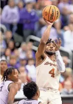  ?? CAPITAL-JOURNAL EVERT NELSON/THE ?? Texas junior guard Tyrese Hunter (4) shoots under the basket during a March 13 game at T-mobile Center in Kansas City, Mo.