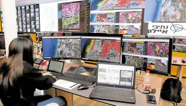  ?? ?? ON TRACK An air traffic controller looks at screens set up in the coastal city of Tel Aviv to monitor the location and flight routes of drones crisscross­ing the skies over Israel.