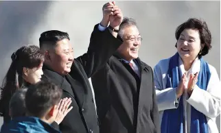  ?? AFP ?? NORTH KOREAN LEADER Kim Jong Un (second from the left) and his wife Ri Sol Ju (left) pose with South Korean President Moon Jae-in (second from the right) and his wife Kim Jung-sook (right) on the top of Mount Paektu in this Sept. 20 photo after their summit. Messrs. Kim and Moon visited the spiritual birthplace of the Korean nation that day for a show of unity after their North-South summit gave new momentum to Pyongyang’s negotiatio­ns with Washington.