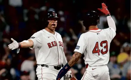  ?? MICHAEL DWYER/ASSOCIATED PRESS ?? Rafael Devers (left) greets Ceddanne Rafaela at home plate after he scored on Jarren Duran’s two-run triple.