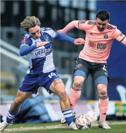  ?? Picture: Robbie Stephenson/JMP ?? Luke McCormick, of Bristol Rovers, left, and Sheffield United’s John Fleck battle for the ball during Saturday’s FA Cup third-round tie at the Memorial Stadium
