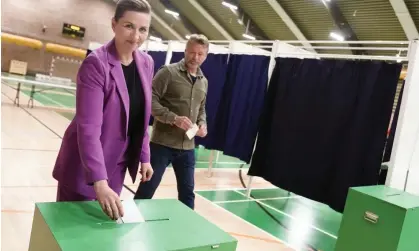  ?? Photograph: Liselotte Sabroe/AP ?? Mette Frederikse­n and her husband Bo Tengberg vote in Denmark’s referendum.