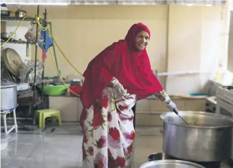  ?? Reem Mohammed / The National ?? Fatima Al Yamahi prepares food at her house on a Ramadan afternoon using cereals and spice in her recipes. Empty Vimto bottles in Ms Al Yamahi’s kitchen, to be filled with dihn, pure cow ghee