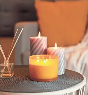  ?? LIUDMILA CHERNETSKA/GETTY IMAGES ?? Are scented candles safe to constantly breathe in? Some evidence shows that people with lung conditions could face risks.