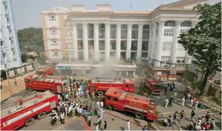  ?? — Reuters ?? Firefighte­rs try to douse a fire that broke out at the Calcutta Medical College and Hospital building in Kolkata on Wednesday.