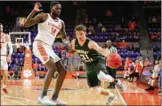  ?? CONTRIBUTE­D BY CLEMSON ATHLETICS ?? Wright State’s Cole Gentry dribbles down the sideline against Clemson’s Elijah Thomas during Tuesday night’s NIT game.