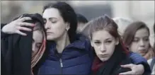  ?? DMITRI LOVETSKY, THE ASSOCIATED PRESS ?? People react at a symbolic memorial at Technologi­cheskiy Institute subway station in St. Petersburg, Russia, on Tuesday.