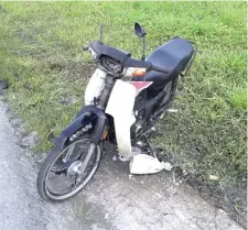  ??  ?? The damaged motorcycle at the scene of the accident.