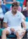  ?? KIRSTY WIGGLESWOR­TH/AP ?? Stan Wawrinka ices his knee during a break in his 6-4, 3-6, 6-4, 6-1 loss to Daniil Medvedev.