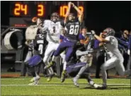  ?? BARRY TAGLIEBER - FOR DIGITAL FIRST MEDIA ?? Phoenixvil­le’s Anthony Stevenson goes high as the ball falls just out of reach as Pottsgrove’s Jimai Springfiel­d defends in the end zone at the end of the first half Friday.