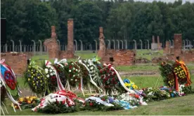  ?? Photograph: Wojciech Grabowski/Sopa Images/Rex/Shuttersto­ck ?? Wreaths and flowers mark Roma and Sinti Genocide Remembranc­e Day on 2 August 2021 at the former Auschwitz II Birkenau concentrat­ion/death camp in Brzezinka, Poland.