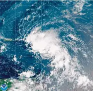  ?? NOAA VIA AP ?? This satellite image released by the National Oceanic and Atmospheri­c Administra­tion (NOAA) shows Tropical Storm Laura in the Atlantic Ocean Friday.