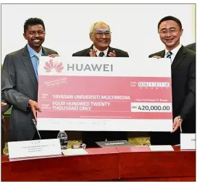  ??  ?? Prof Ahmad Rafi (left) receives the mock cheque from Zhou (right) at the signing ceremony while Zaki (middle) looks on.