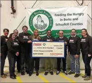  ?? SUBMITTED PHOTO ?? Dunkin’ Donuts franchisee­s donated $21,000 to the Greater Berks Food Bank. A check was recently presented to the food bank.