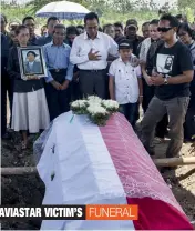  ?? — AFP ?? Family members of flight technician Hendrikus Soekris Winarto, a victim of the crashed Aviastar plane, attend her funeral in Sidoarjo, East Java, on Thursday. Rescuers on October 5 found the wreckage of a plane carrying 10 people that disappeare­d...