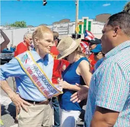  ?? STEVEN LEMONGELLO/STAFF ?? U.S. Sen. Bill Nelson speaks with people at the Florida Puerto Rican Parade and Festival in Orlando on April 28. On Friday, he made his third visit to Puerto Rico since Hurricane Maria.