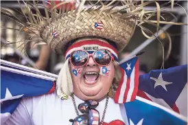  ?? AP ?? A resident celebrates along 5th Avenue, New York City, during the National Puerto Rican Day Parade yesterday.