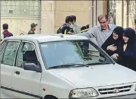  ?? REUTERS ?? Family members of Colonel Hassan Sayyad Khodaei weep over his body in his car after he was shot in Teheran on Sunday.