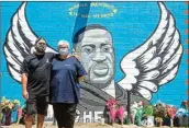  ?? PTI ?? Artists Alex Roman, better known as Donkeeboy, and his mother Sylvia Roman, better known as Donkeemom, pose in front of their mural honoring George Floyd, in Houston