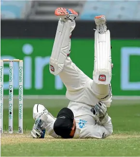  ?? AP ?? New Zealand wicketkeep­er BJ Watling takes a tumble at the MCG yesterday during Australia’s second innings.