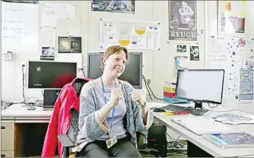  ?? SHIMBUN (JAPAN)/ASIA NEWS NETWORK RYUZO SUZUKI/THE YOMIURI ?? Surrounded by computers and space memorabili­a, Jaxa scientist Elizabeth Tasker speaks in her office at the Institute of Space and Astronauti­cal Science in Sagamihara, Kanagawa prefecture.