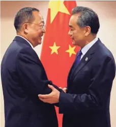  ?? BULLIT MARQUEZ, AP ?? North Korean Foreign Minister Ri Yong Ho, left, is greeted by his Chinese counterpar­t, Wang Yi, Sunday in Manila.