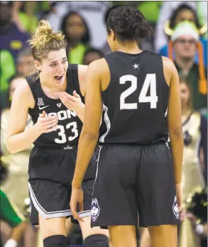  ?? Robert Franklin / Associated Press ?? UConn’s Katie Lou Samuelson (33) talks to teammate Napheesa Collier (24) after taking a hit to the face during Sunday’s 89-71 win at Notre Dame in South Bend, Ind.