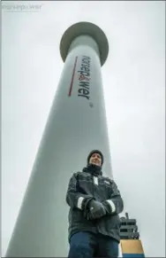  ?? NORSEPOWER VIA AP ?? Tuomas Risk, CEO of Finnish startup company Norsepower, poses in the North Sea, in front of one of his company’s rotor sails, one of the new technologi­es the shipping industry is looking at as it searches for new solutions to cut greenhouse gas emissions to combat climate change.