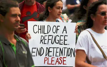  ?? — Reuters ?? Ready to
help: Refugee advocates holding placards as they protest in Sydney against the treatment of asylum seekers at detention centres in Nauru and Manus Island.