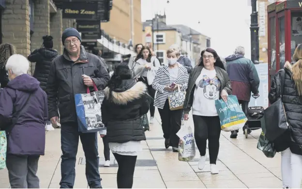  ??  ?? WELCOME BACK: Shoppers have been returning to Halifax town centre as more businesses re-open.