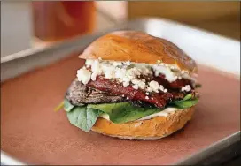  ?? PHOTOS CONTRIBUTE­D BY MIA YAKEL ?? Loyal Q smoked portobello sandwich with roasted red bell pepper, goat cheese, spinach and garlic aioli.