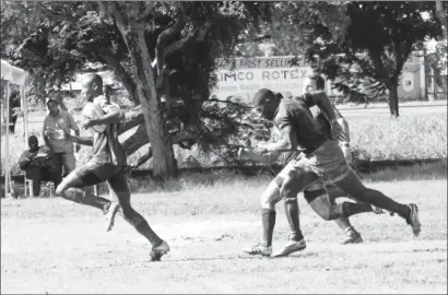  ??  ?? Patrick King evades the Panthers defense on his way to Guyana’s first try in the 64th minute.