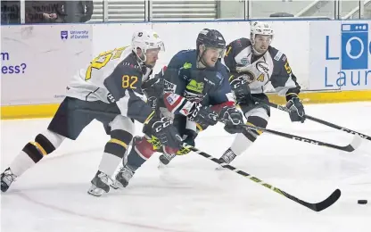  ?? Picture: Derek Black. ?? Stars’ Jordan Cownie comes under pressure from Flames pair Jez Lundin and Kruise Reddick in last night’s game at Dundee Ice Arena.