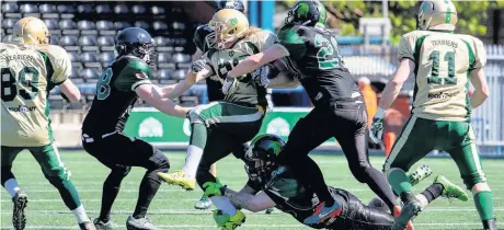  ?? Tim Furfie ?? The Halton Spartans’ defence in action against the Walney Terriers at the Select Security Stadium last season.