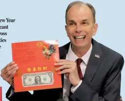  ?? CHEN WEIHUA / CHINA DAILY ?? Leonard Olijar, director of the Bureau of Engraving and Printing under the US Treasury Department, holds a Year of the Rooster 2017 Lucky Money at a press conference on Tuesday. The product will go on sale Wednesday.