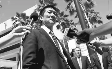  ?? — Reuters photo ?? Hawaii Attorney-General Douglas Chin talks to the media at the US District Court Ninth Circuit after seeking an extension after filing an amended lawsuit against Trump’s new travel ban in Honolulu, Hawaii.