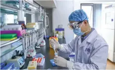  ??  ?? A staff member tests samples of the COVID-19 inactivate­d vaccine at a vaccine production plant of China National Pharmaceut­ical Group (Sinopharm) in Beijing, China, April 11, 2020.