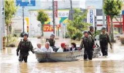  ?? (Reuters) ?? Japan Self-Defence Force soldiers rescue people from a flooded area in Mabi town in Kurashiki, Okayama Prefecture, Japan, July 8, 2018.
