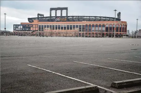  ?? JOHN MINCHILLO/AP PHOTO ?? Parking lots sit empty surroundin­g Citi Field, home of the New York Mets, on Wednesday. There will be empty ballparks in 15 cities today on what was supposed to be Major League Baseball’s opening day, including the Mets hosting the reigning world champion Washington Nationals at 1:10 p.m. The start of the regular season is indefinite­ly on hold because of the coronaviru­s pandemic.