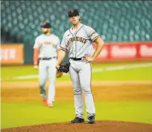  ?? David J. Phillip / Associated Press ?? Giants pitcher Caleb Baragar waits to be pulled Wednesday after giving up a threerun homer to Martin Maldonado.