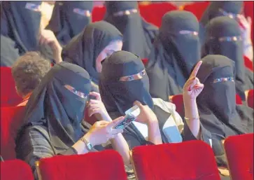  ?? Fayez Nureldine AFP/Getty Images ?? WOMEN attend a short film competitio­n festival at a cultural center in Riyadh in October. Saudi Arabia’s movie theater announceme­nt raised questions about the kinds of censorship the kingdom is likely to impose.