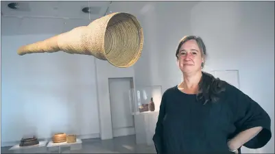  ??  ?? HISTORY PIECE: Ararat Gallery TAMA manager Jacqueline Grenfell with a large eel trap created by one of Australia’s foremost First Nations weavers, Yvonne Koolmatrie. Picture. PAUL CARRACHER