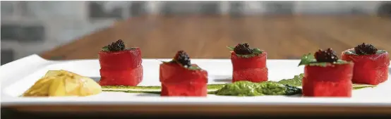  ?? Yi-Chin Lee / Houston Chronicle ?? A well-spiced ribbon of avocado mousse gooses the Tuna Watermelon Sashimi at a’Bouzy.