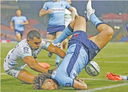  ??  ?? Rookie Fijian winger Mark Nawaqanita­wase scores a try against Blues in Newcaslte in Sydney, Australia on February 7, 2020. He has scored three tries during the 2020 Super Rugby and is on the bench tomorrow against Rebels.