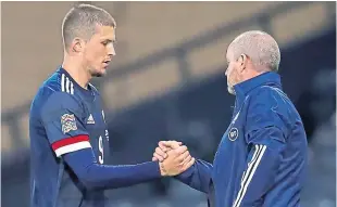  ?? Picture: PA. ?? Lyndon Dykes is congratula­ted for his performanc­e by manager Steve Clarke after being substitute­d.