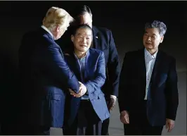  ?? TOM BRENNER/NEW YORK TIMES ?? President Donald Trump (left) shakes hands with Kim Dong-chul as Kim Hak-song (right) looks on early Thursday morning at Joint Base Andrews, Md. The pair and fellow freed prisoner Tony Kim were transporte­d to Walter Reed National Military Medical...